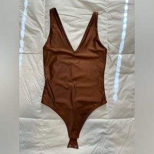 Never worn! XS Babaton Satinette v-neck bodysuit in Epicurean brown